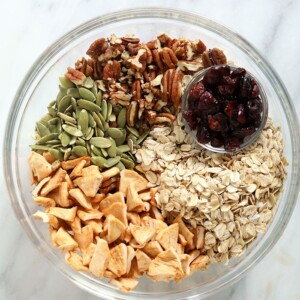 Ingredients for apple cinnamon granola in a bowl.