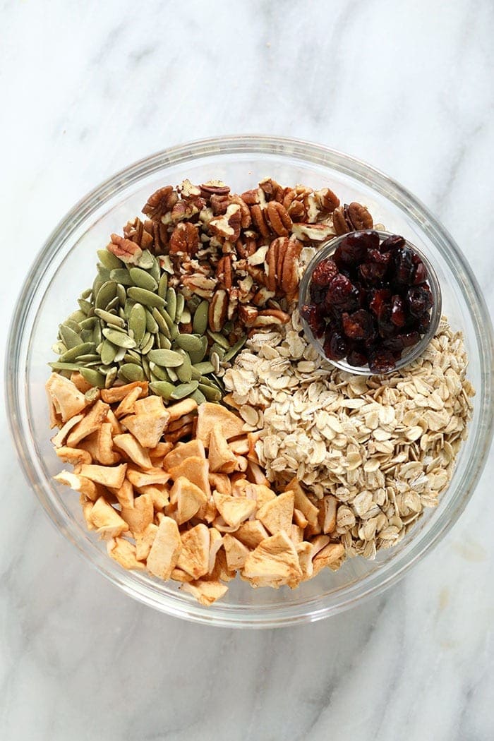 Ingredients for apple cinnamon granola in a bowl.