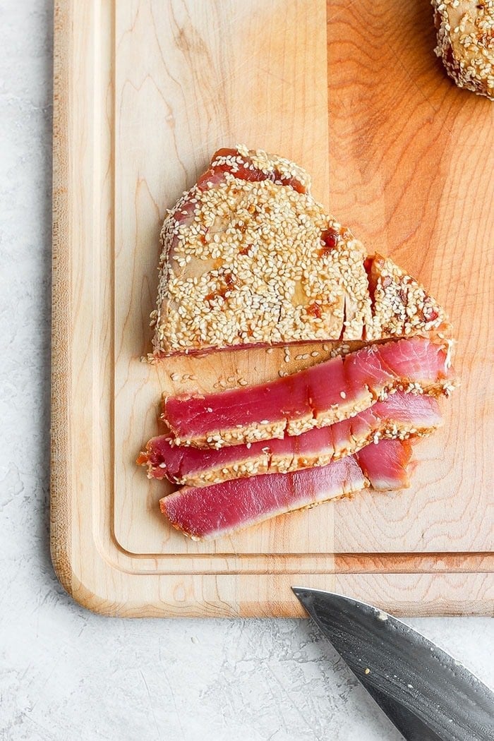 seared ahi tuna steak on a cutting board.