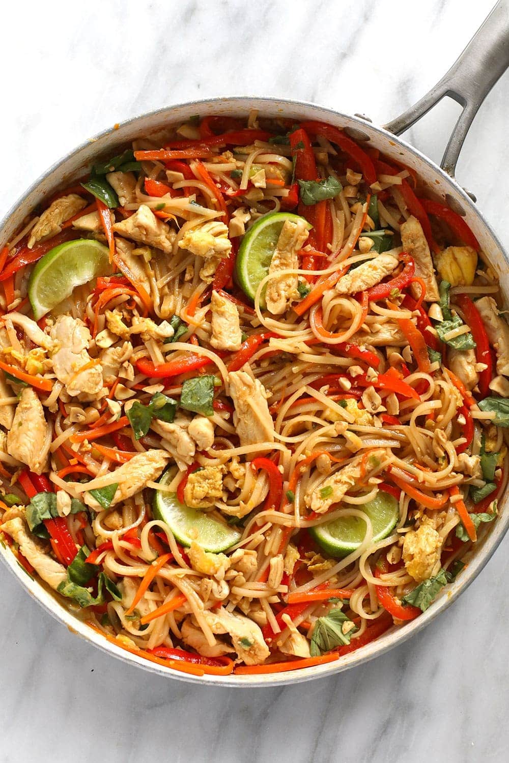 Chicken pad Thai mixed together and ready to eat in a pan. 