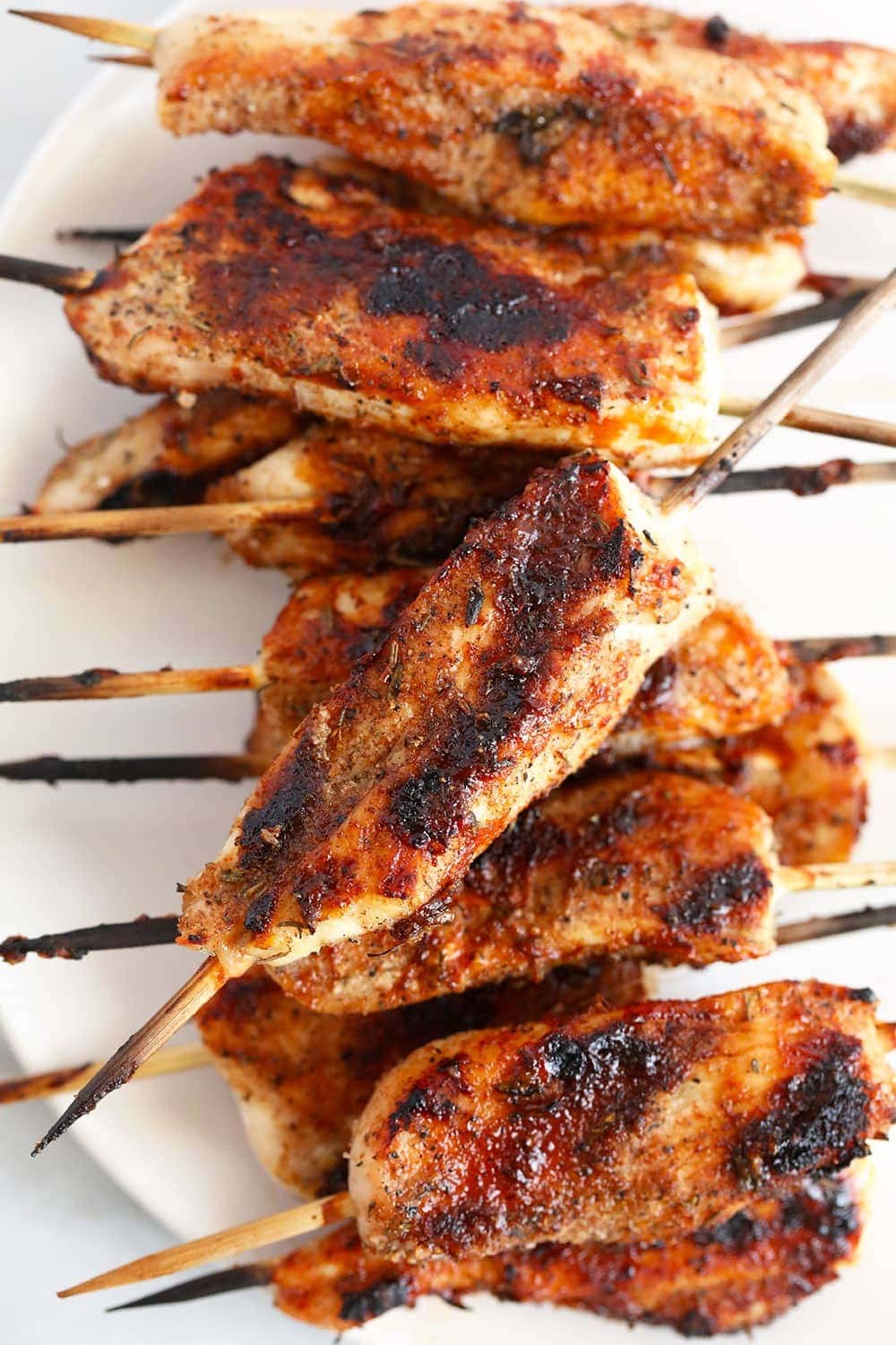 Grilled chicken skewers on a plate.