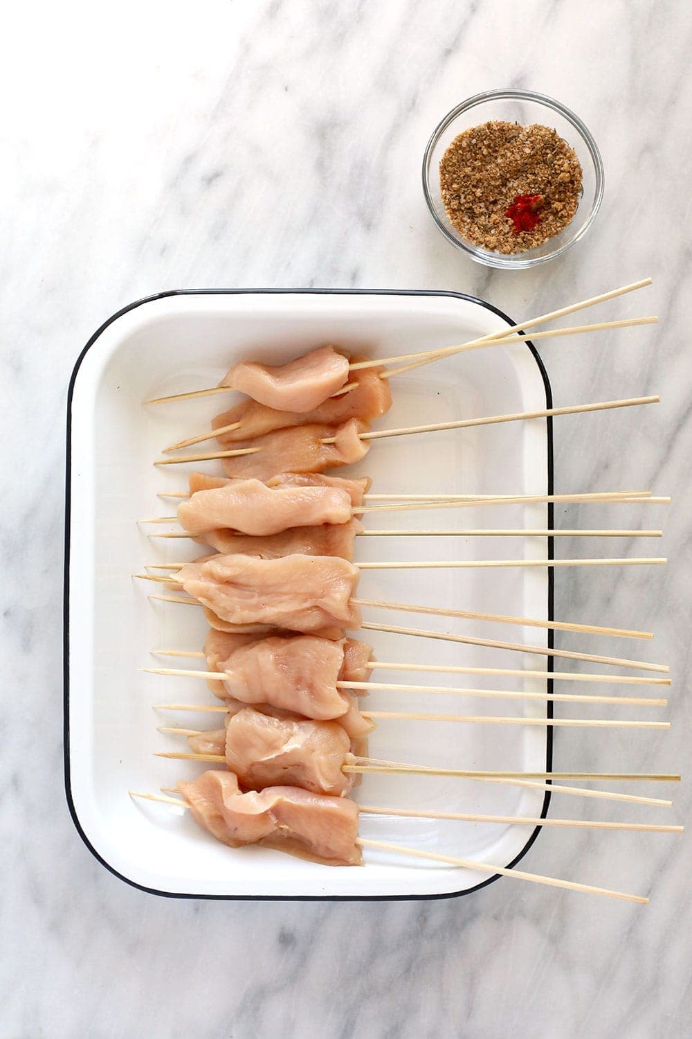 Raw chicken on skewers.