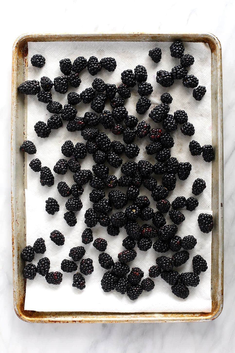 blackberries on a baking sheet and paper towel drying