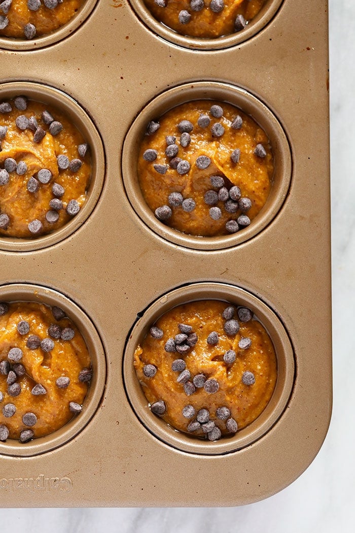 Gluten free pumpkin muffin batter in a pan