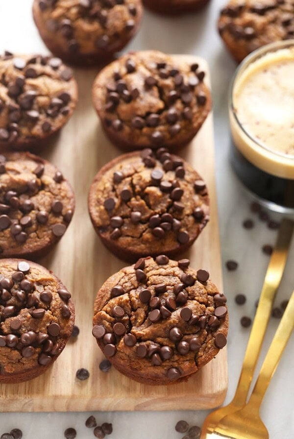 Gluten-free chocolate chip muffins on a wooden cutting board.