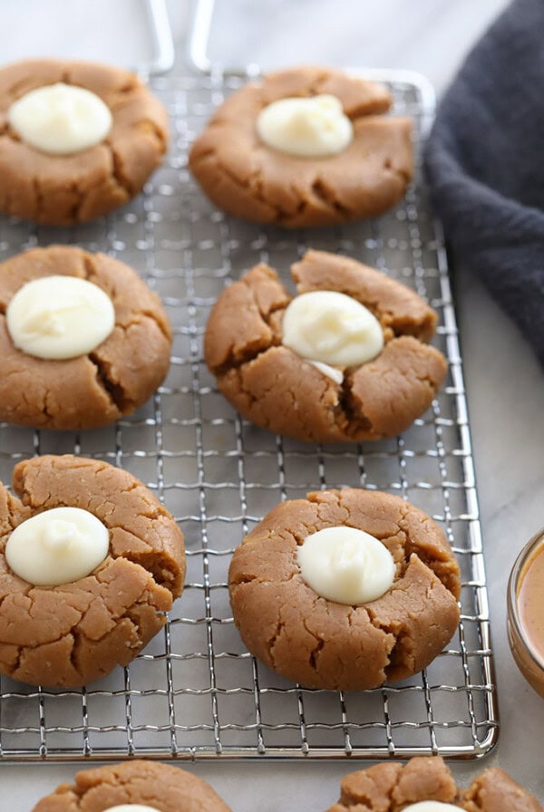 No bake peanut butter thumbprint cookies on a cooling rack.