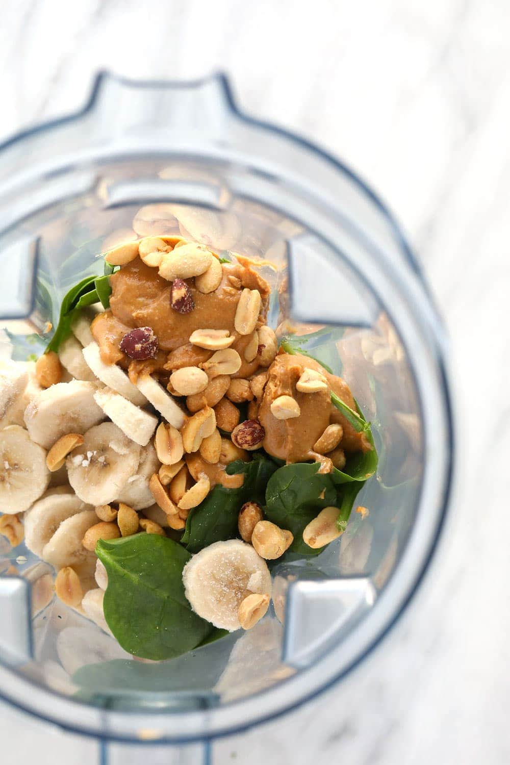 Ingredients for the peanut butter green smoothie in a blender