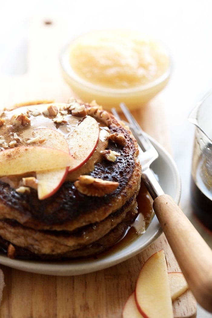 applesauce pancakes topped with apple slices ready to be eaten