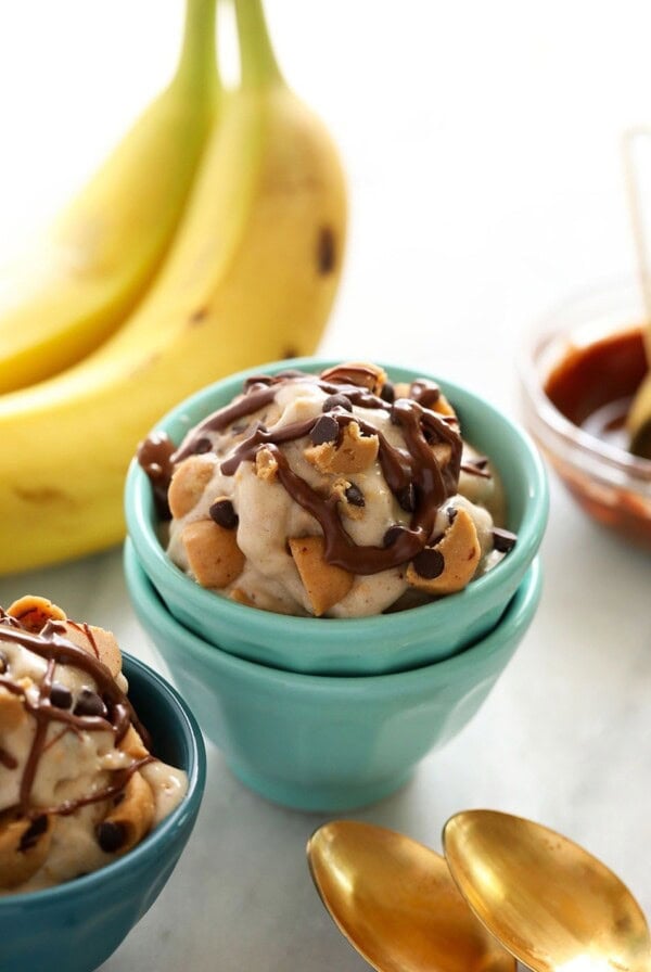 Two bowls of banana nice cream with chocolate sauce.