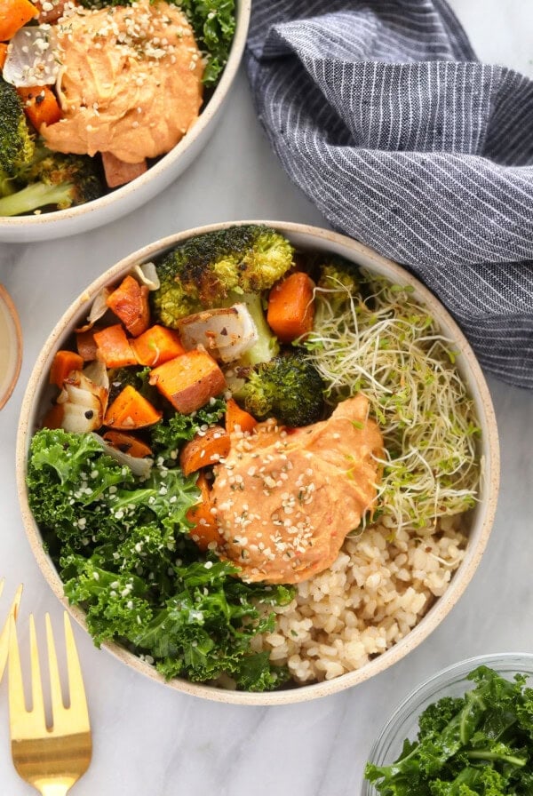 vegetarian brown rice bowl topped with hummus