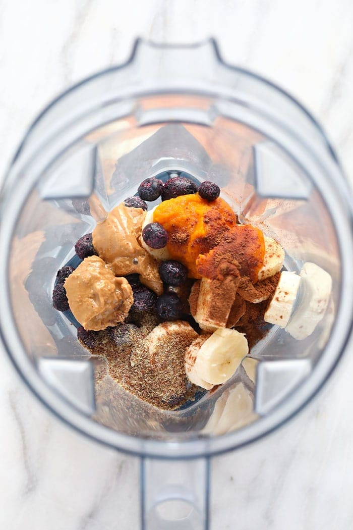 Pumpkin berry smoothie ingredients in a blender