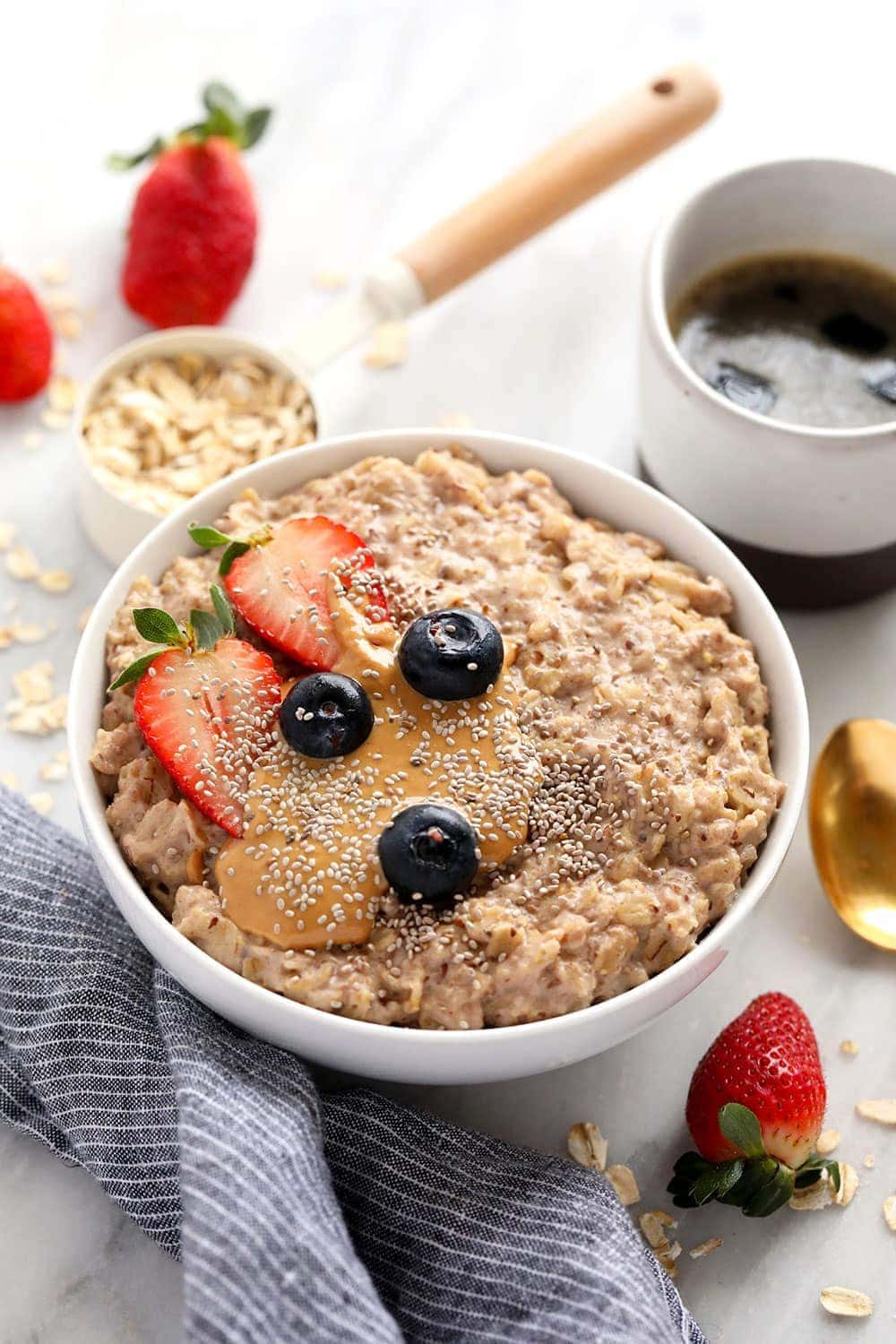 superfood oatmeal bowl topped with berries and nut butter