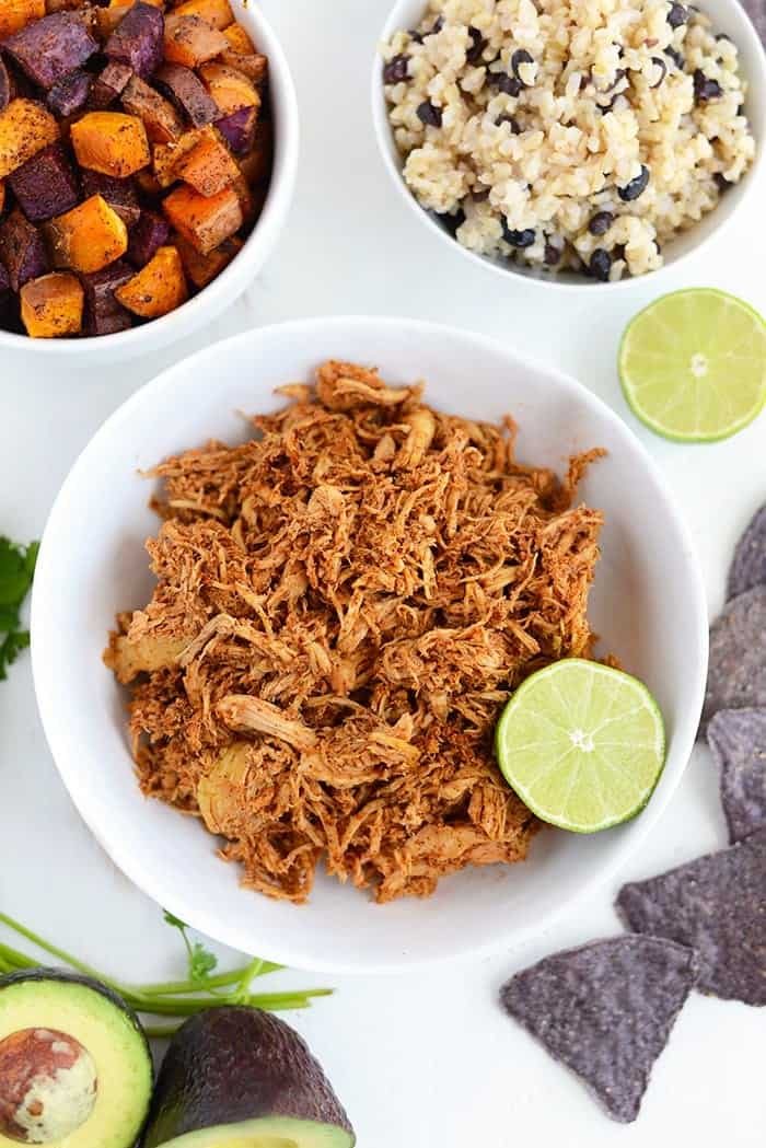 Crock pot chicken next to bowl of sweet potatoes and long grain rice