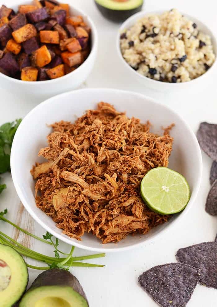 prepared ingredients for crock pot chicken taco bowls on white table 