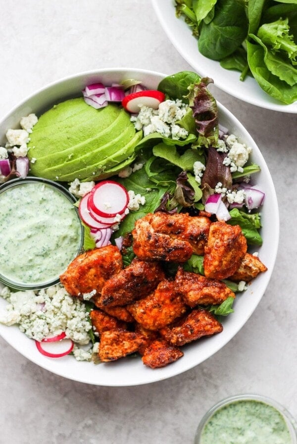 a bowl of sriracha chicken salad with avocado.