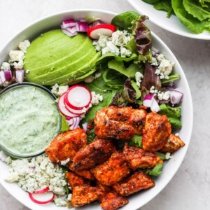 A sriracha chicken salad with avocado and radishes.