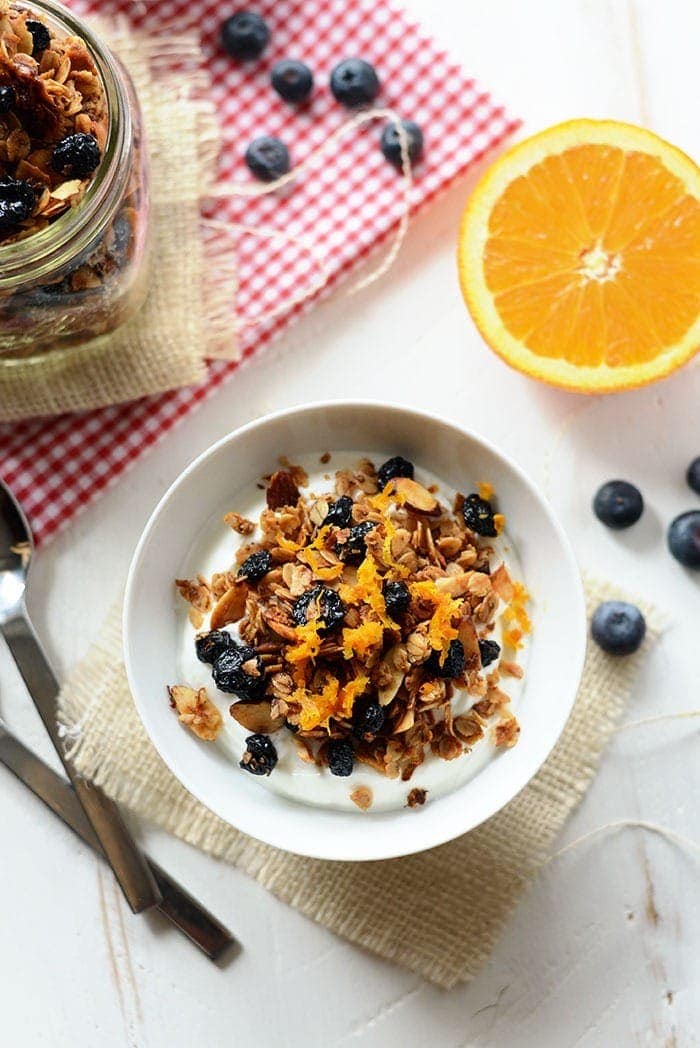 blueberry orange granola in a bowl with milk