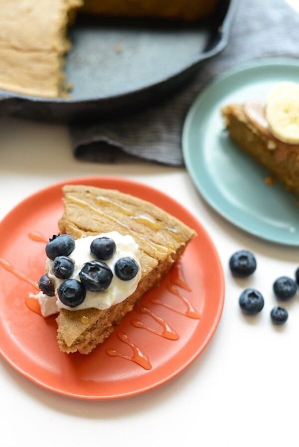 A banana pancake slice with blueberries served on a plate for breakfast.