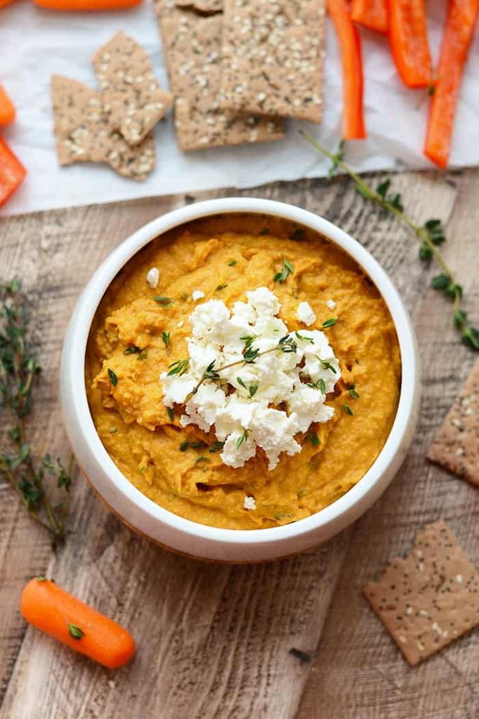 sweet potato hummus with goat cheese in white bowl