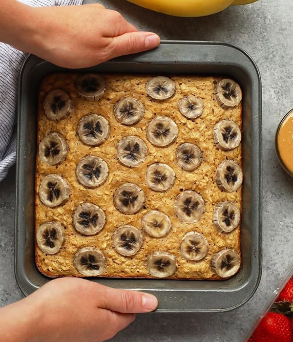 Baked oatmeal queens do we have a recipe for you! This Peanut Butter Banana Baked Oatmeal is perfectly sweetened with mashed banana and a little bit of maple syrup and gluten-free made with ground oat flour and rolled oats. Make this on the weekend for the family or during the week for a healthy breakfast meal prep recipe.