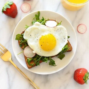 A Toast Tuesday breakfast sandwich with a fried egg and radishes.