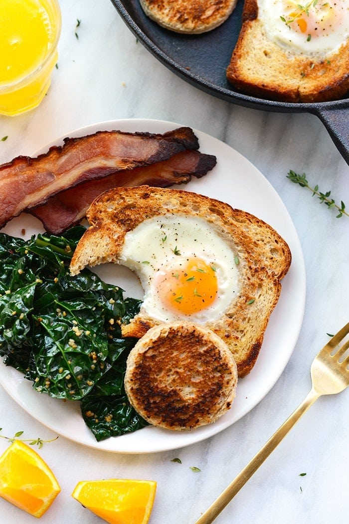 eggs in a basket with bite taken out of it on plate