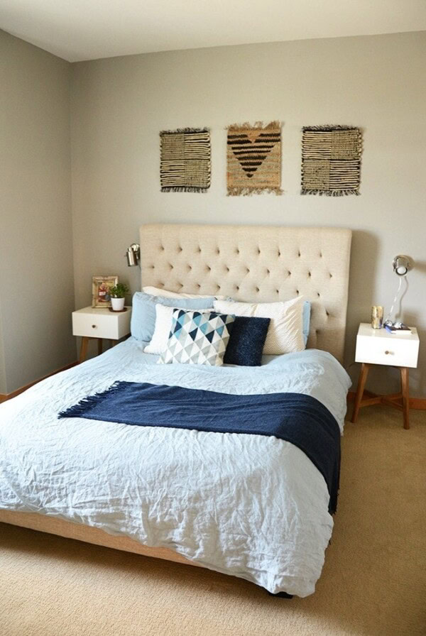 a bedroom with a white bed and blue pillows.