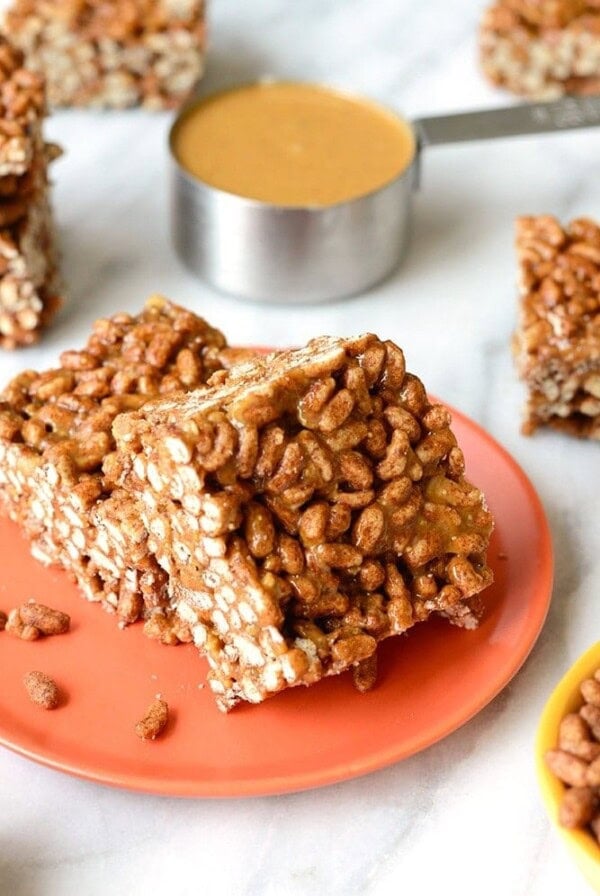 peanut butter rice crispy treats on an orange plate.