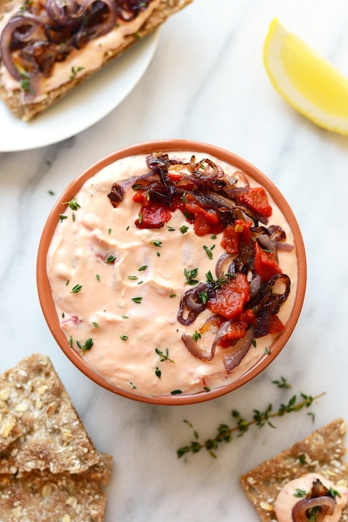 With Sunday football back in action, this Skinny Roasted Red Pepper and Goat Cheese Dip makes for the most perfect appetizer. It's made with a non-fat Greek yogurt base, pureed roasted red peppers, and goat cheese! 