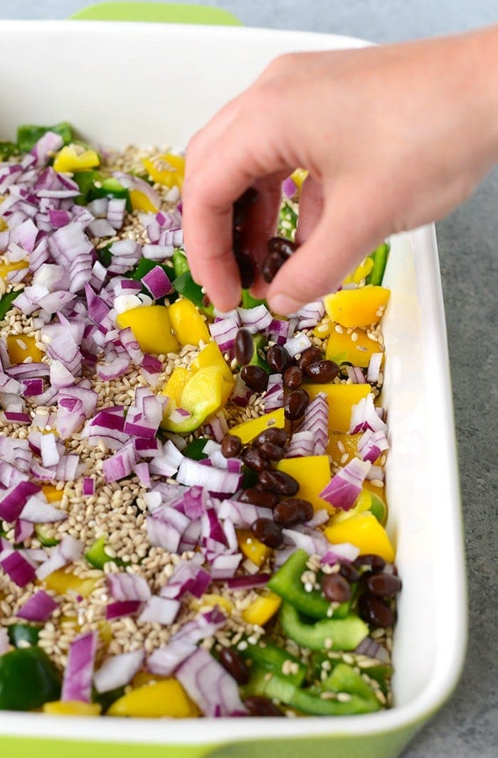 In just 60 minutes you can make this healthy chicken enchilada casserole that's packed with lean chicken, beans, tons of veggies, and brown rice. Throw everything into a casserole dish uncooked (that's right...UNCOOKED) and you've got yourself dinner for the entire family.