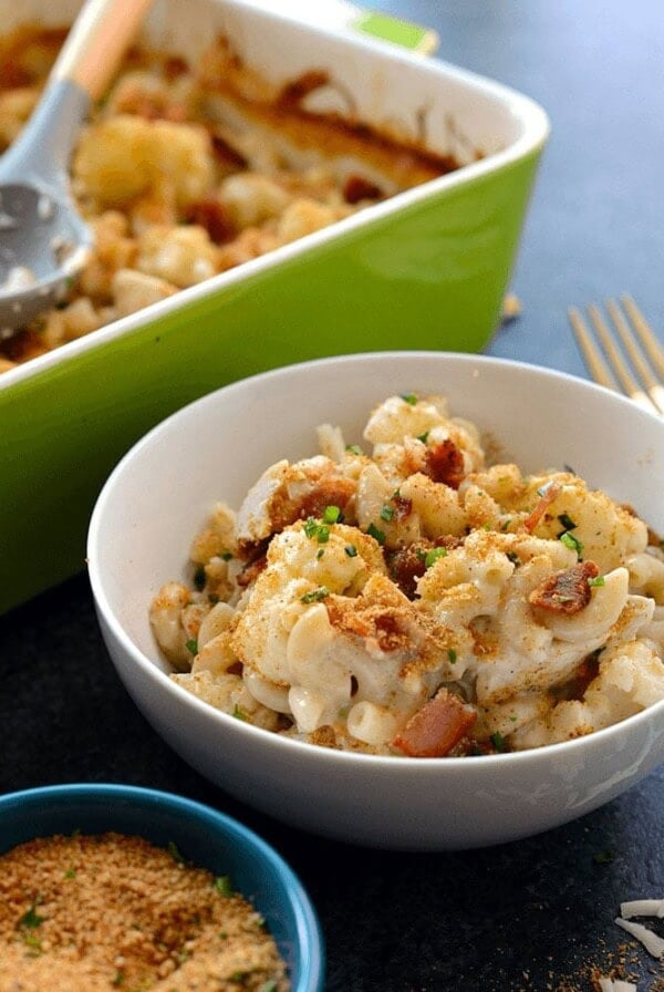 A bowl of chicken mac and cheese with a spoon next to it