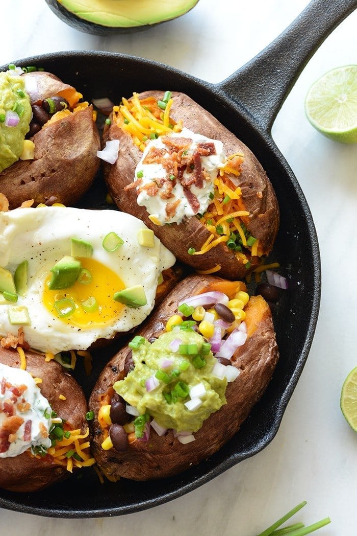 3 varieties of stuffed sweet potatoes in a cast iron skillet