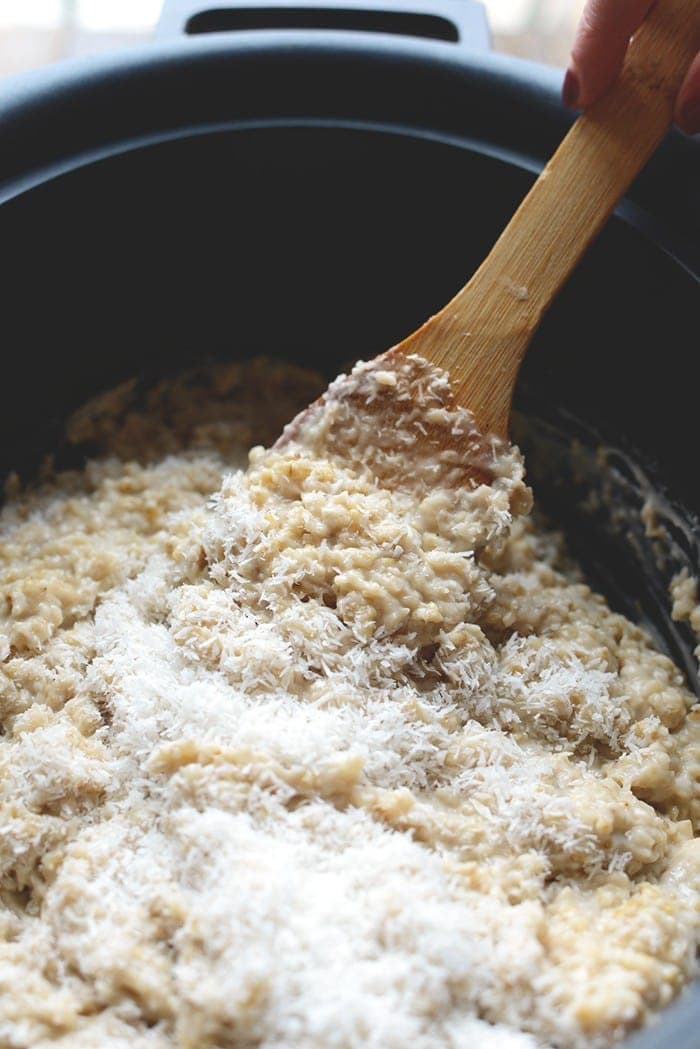 Use your slow cooker to make this decadent Crock Pot Samoa Steel Cut Oatmeal made with a coconut oatmeal base topped with homemade date caramel and a drizzle of chocolate! 