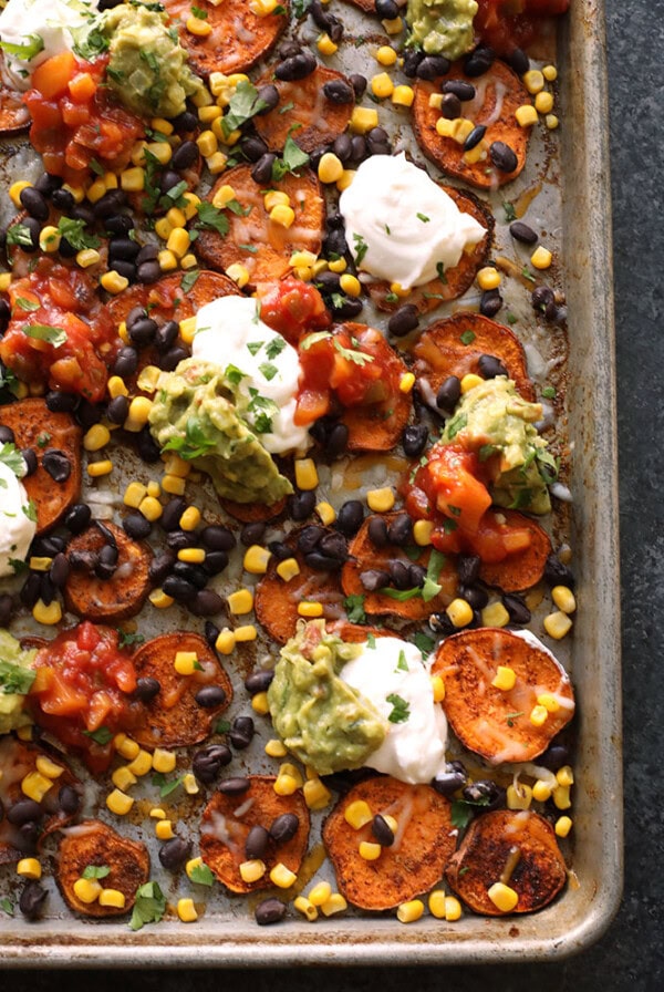 Sweet potato nachos arranged on a baking sheet.