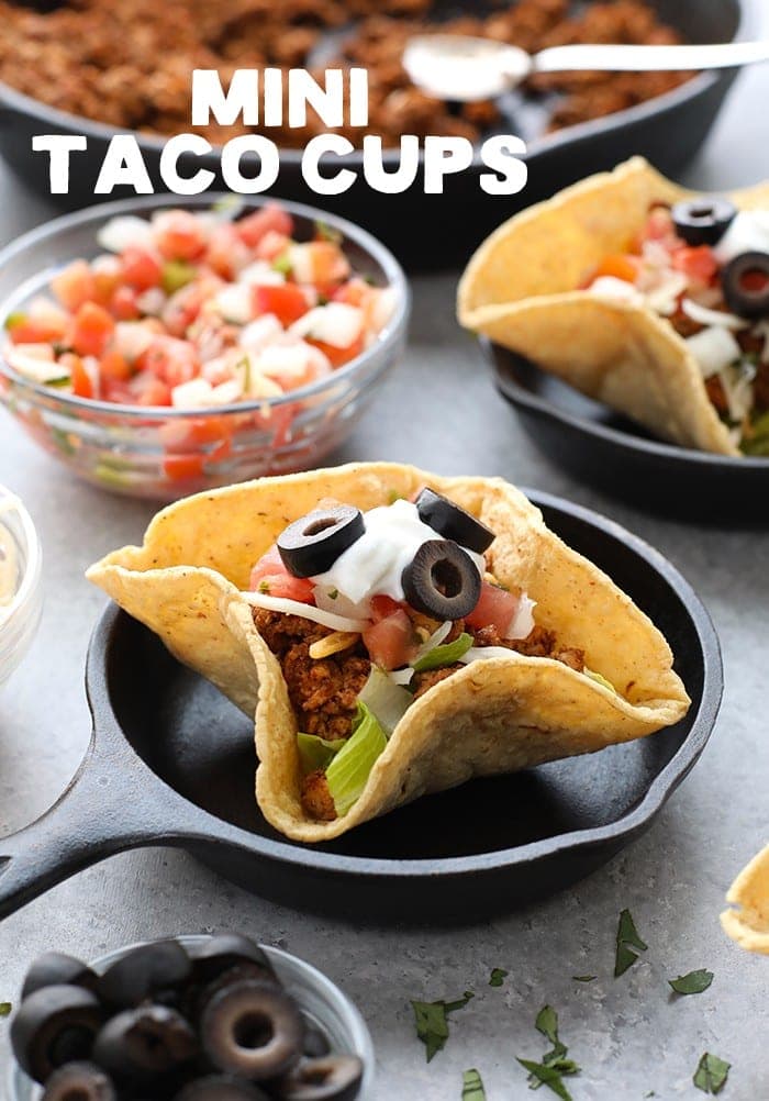 Mini taco cups on a plate.