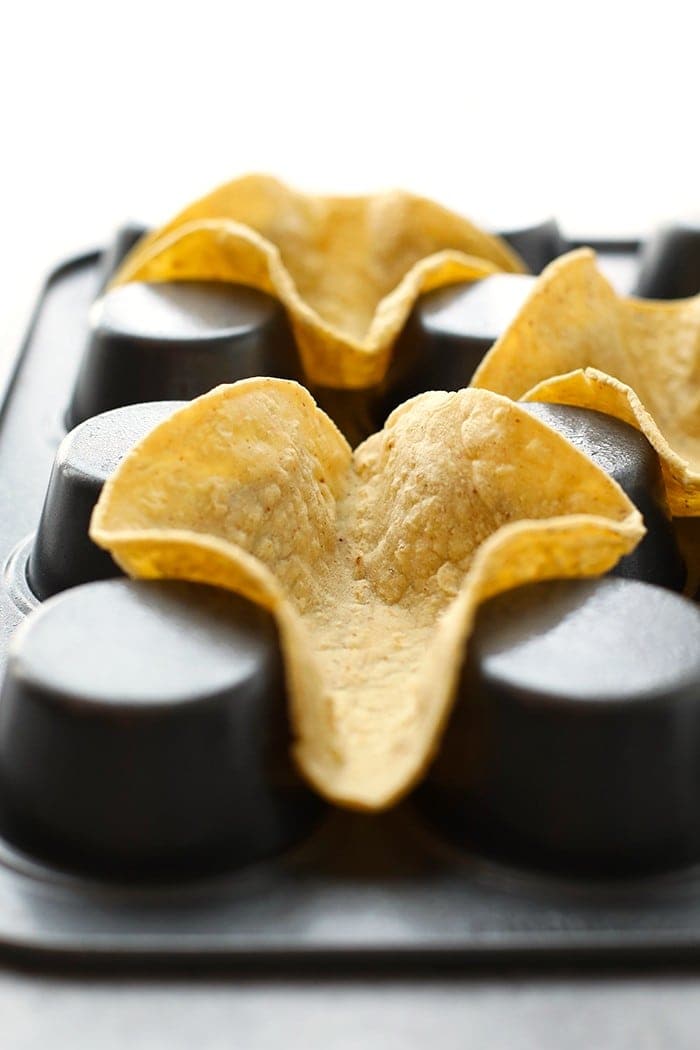 Taco shells in an upside down muffin tin.