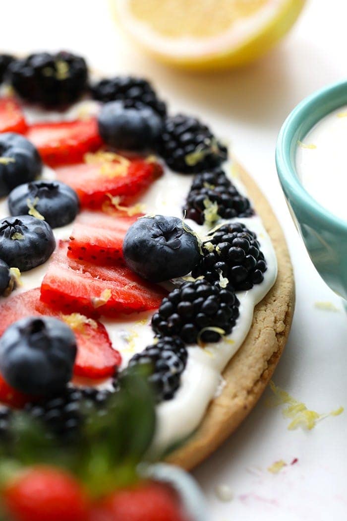 Delicious healthy fruit pizza with berries and lemon zest.