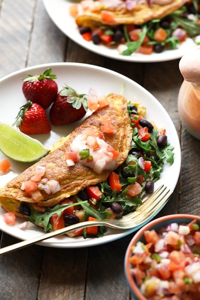 veggie omelette with black beans and strawberries on the side