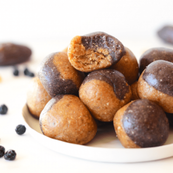 Chocolate peanut butter balls on a white plate.