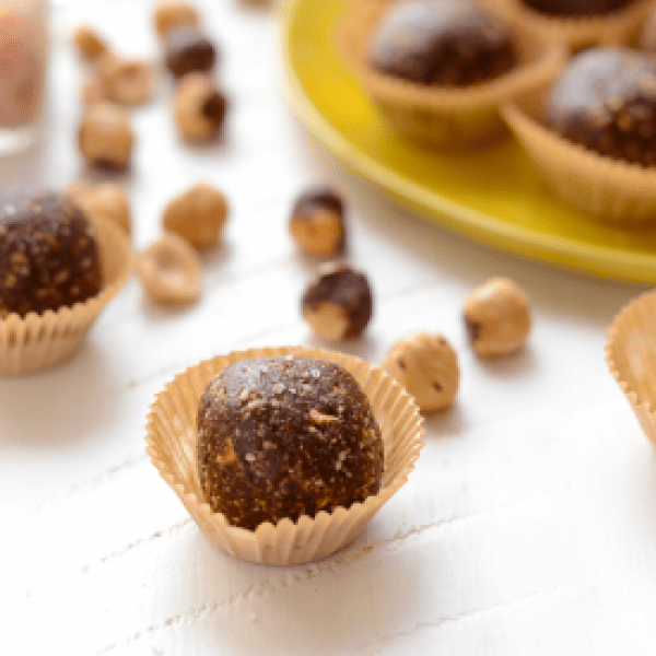 Chocolate hazelnut truffles on a yellow plate.