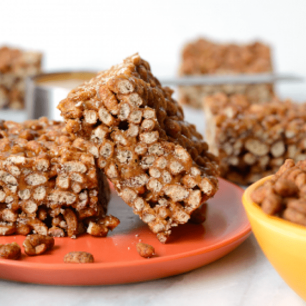 Peanut butter granola bars on an orange plate.