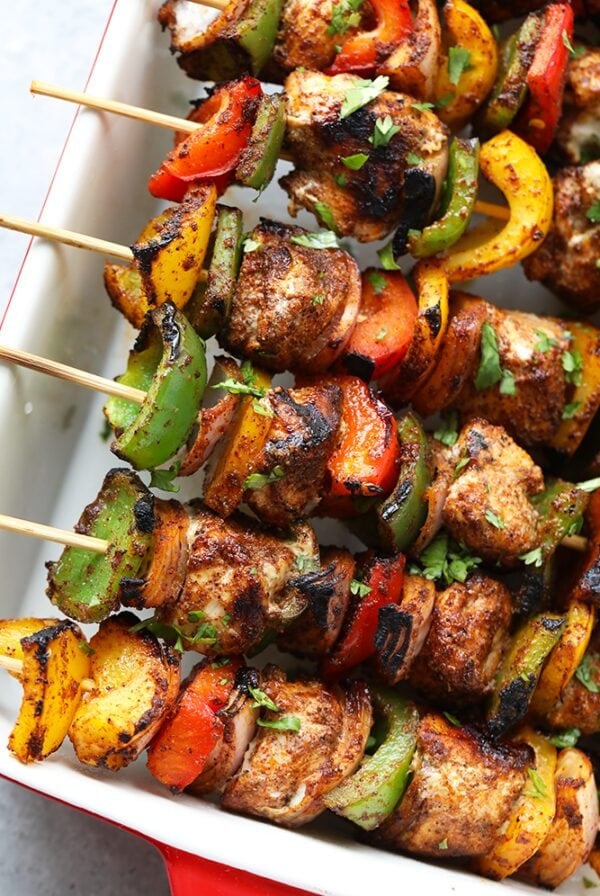 chicken fajita kabobs in casserole dish.