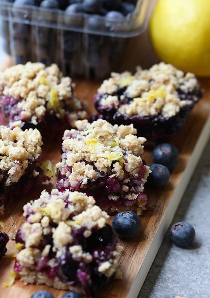 Lemon blueberry crumble bars on a cutting board.