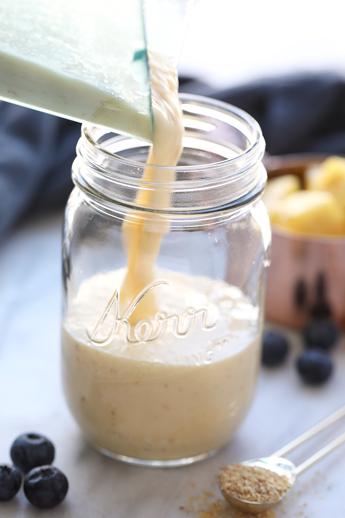 Pouring smoothie into glass