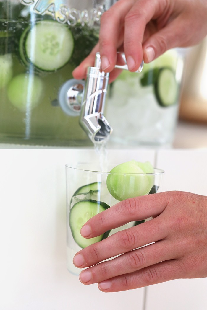 cucumber vodka drinks being dispensed in glass