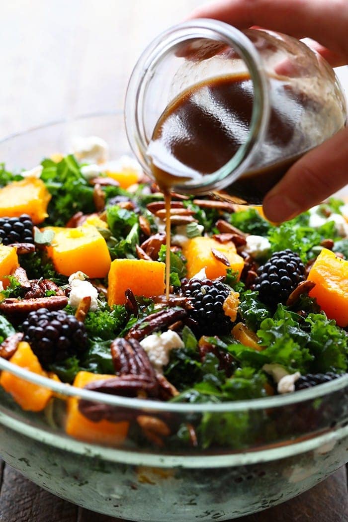 pouring dressing into salad
