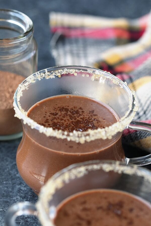 Three glasses of hot chocolate on a table.