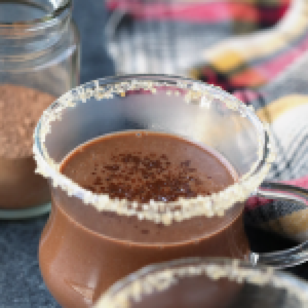 Mugs of hot chocolate on a table.