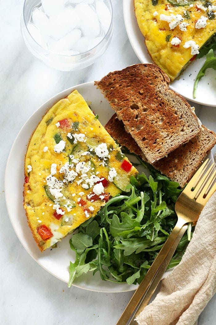 Plated frittata, toast, and arugula. 