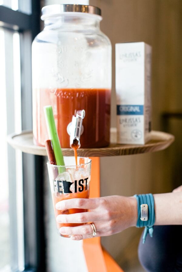 a vulnerable woman holding a glass of bloody mary.